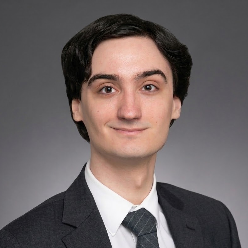 White man with dark-brown hair, wearing a suit